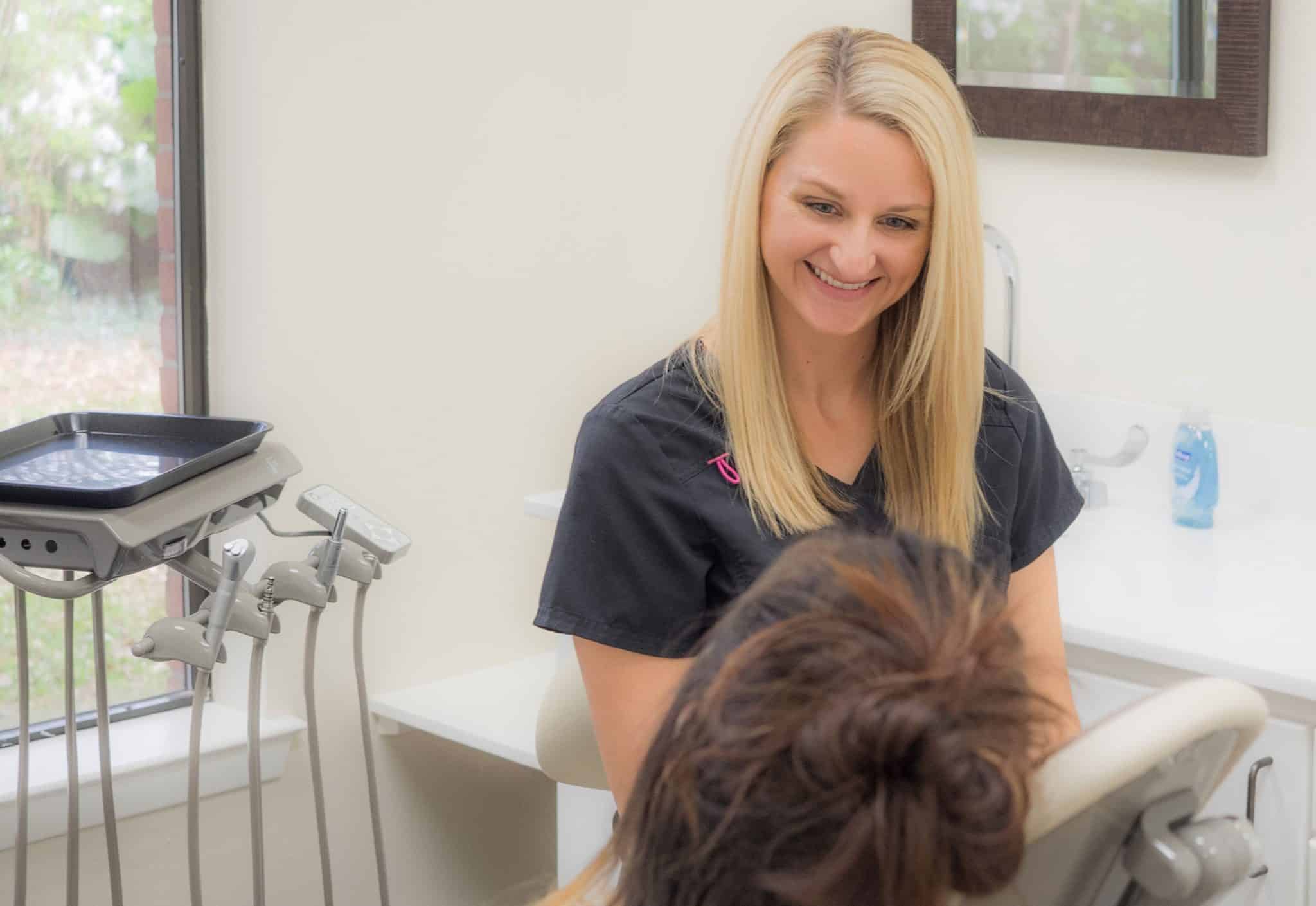 Dr. Carmouche happily chats with one of her patients.